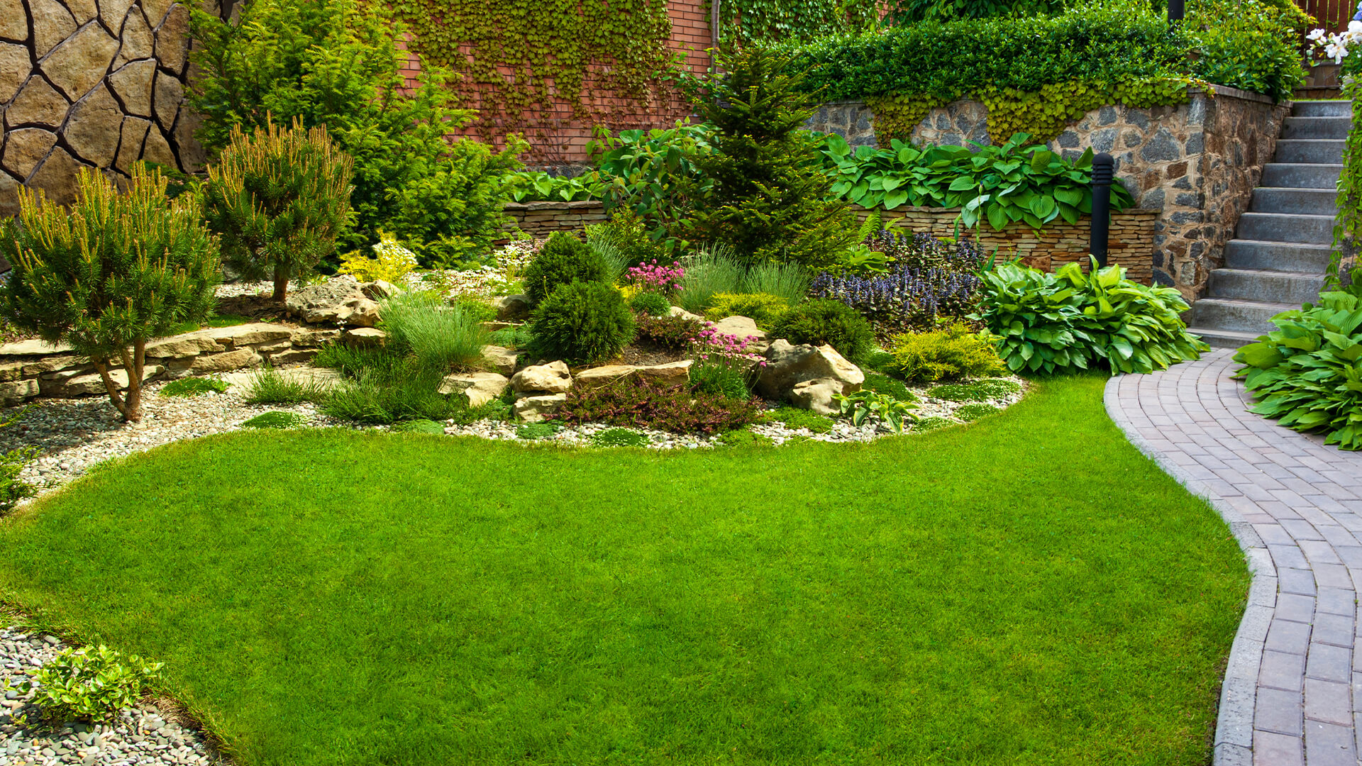 Beautifully designed landscape garden with stone pathways and lush greenery